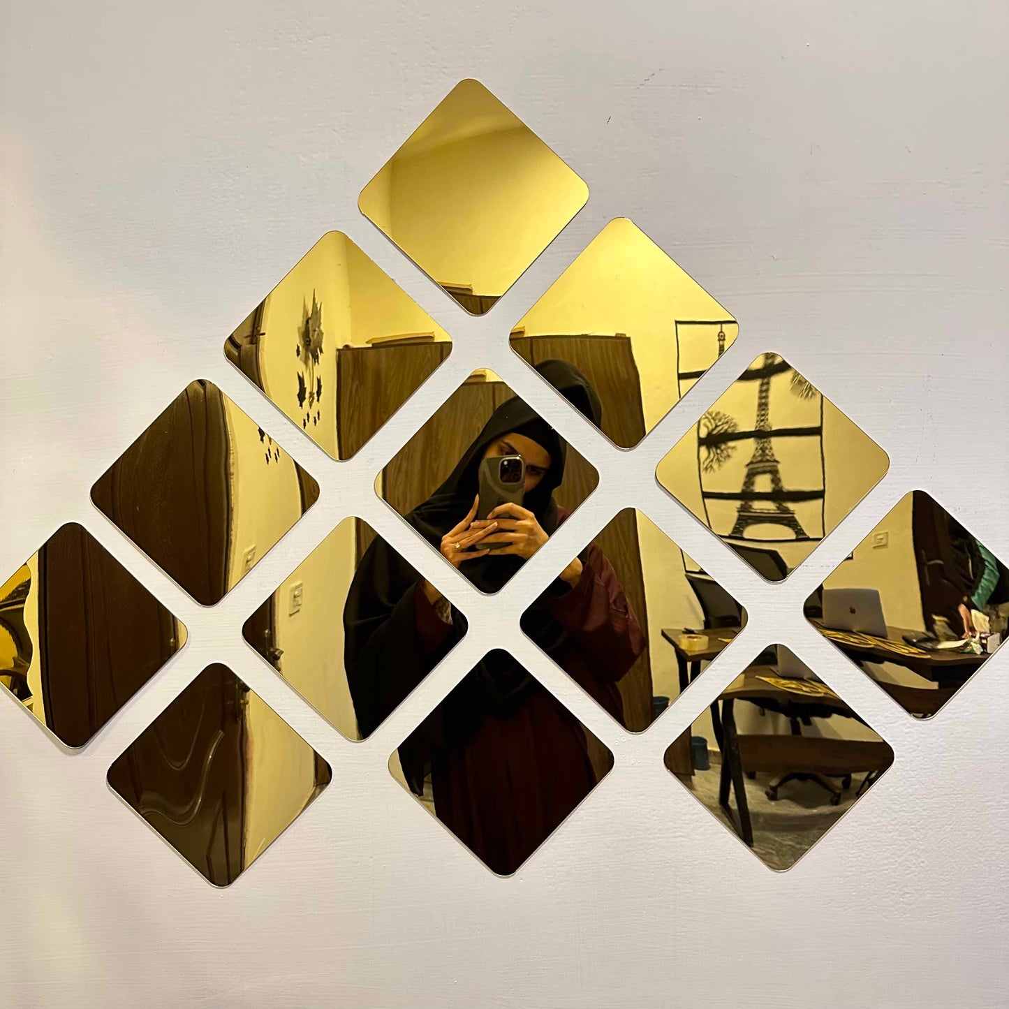 Close-up of DIY 3D acrylic mirror wall decor stickers, showcasing their reflective quality and modern aesthetic.