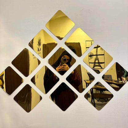 Close-up of DIY 3D acrylic mirror wall decor stickers, showcasing their reflective quality and modern aesthetic.