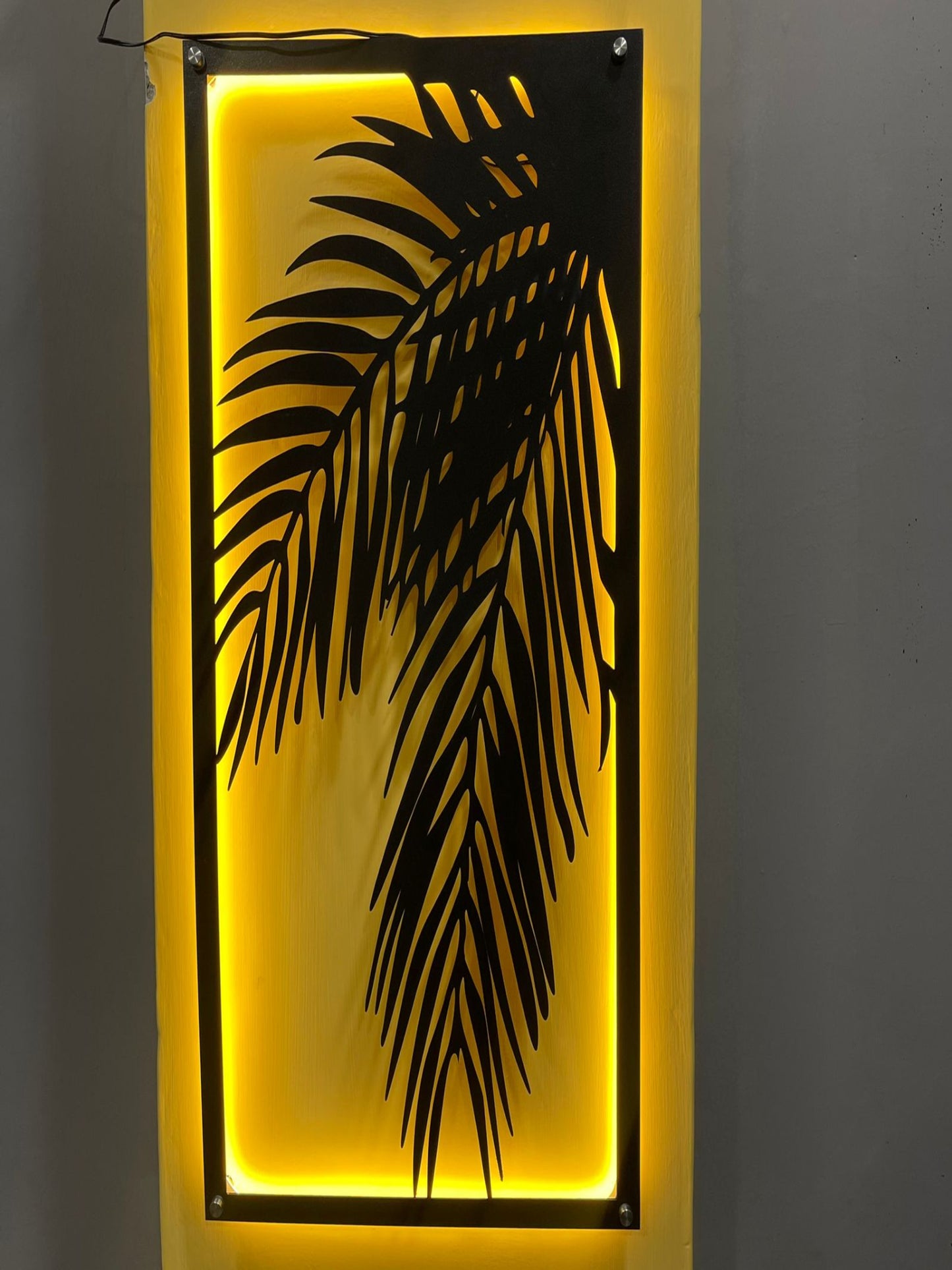 3D bamboo leaf wall art with glowing neon light accent, enhancing modern decor.